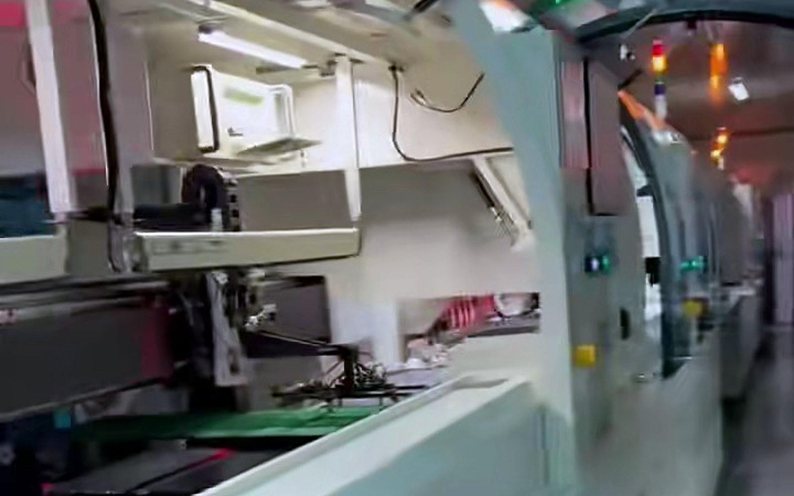 Our own laptop LCD SMT production line with status lights running down the floor